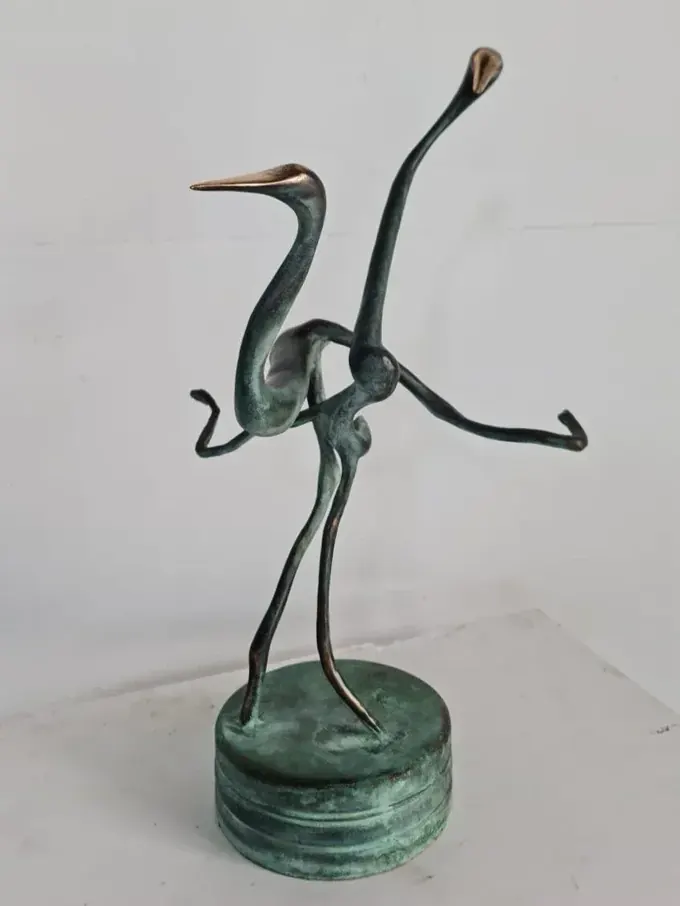 Dancing Cranes, a green-patinated bronze by Bruce Thomson of two cranes caught mid-movement on a round base