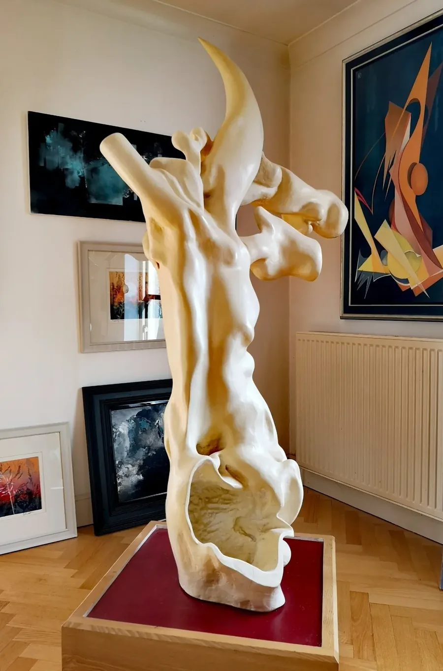 The White Hart, a carved wood sculpture by Bruce Thomson, a tall pale form rising to an antler-like crest