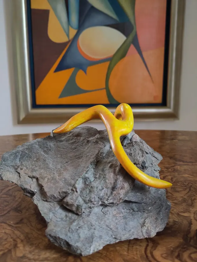 Starfish on a Rock, a sculpture by Bruce Thomson of a carved yellow starfish laid across a grey block of stone